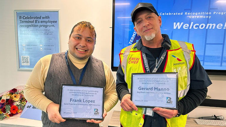 B-Celebrated winners: Two Terminal B employees pose for a photo holding certificates