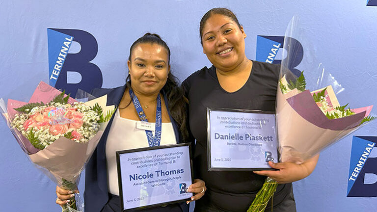 B-Celebrated winners: Two Terminal B employees pose for a photo holding certificates and flowers
