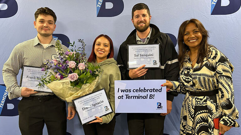 B-Celebrated winners: Four Terminal B employees pose for a photo holding certificates and flowers