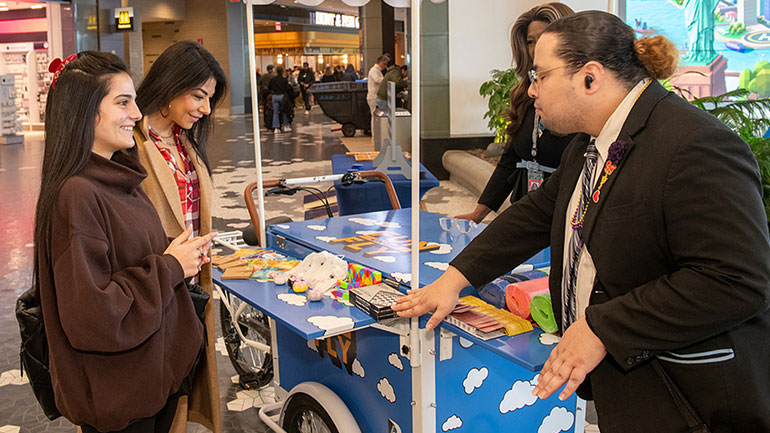 Smiling female travelers experiencing Terminal B's Fun on the Fly